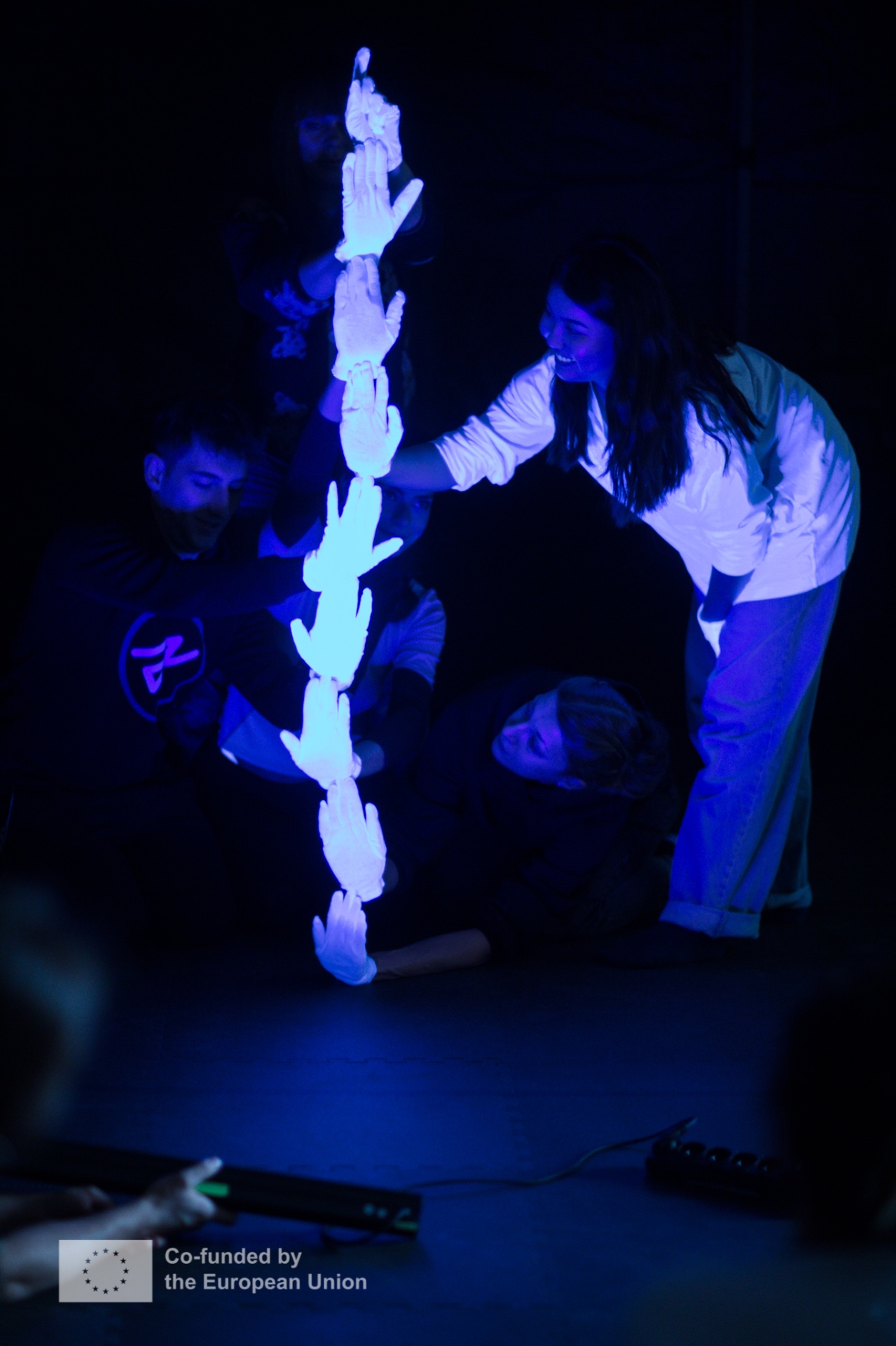Black Light Theatre performance with glowing hands